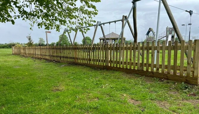 picket fence around a play park in Little Milton